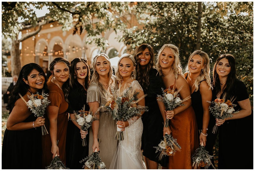 bride and bridesmaids wearing burnt orange dresses