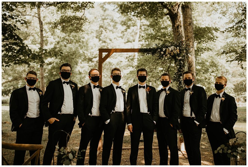 groom and groomsmen wearing masks in portraits on wedding day at the marmalade lily venue