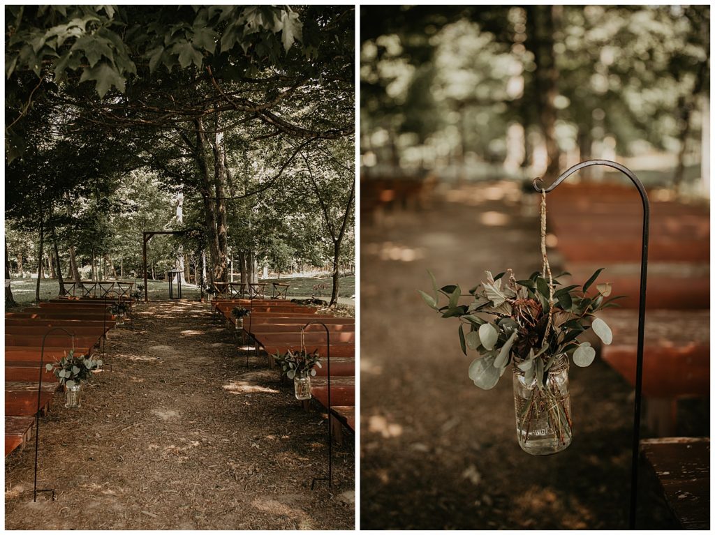 wedding ceremony in the woods with floral arrangements down the aisle