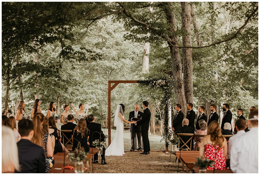 wedding ceremony in the woods at the marmalade lily venue