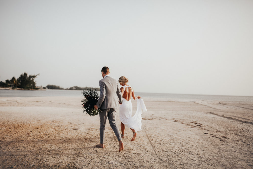 bride and groom on the beach on their wedding day