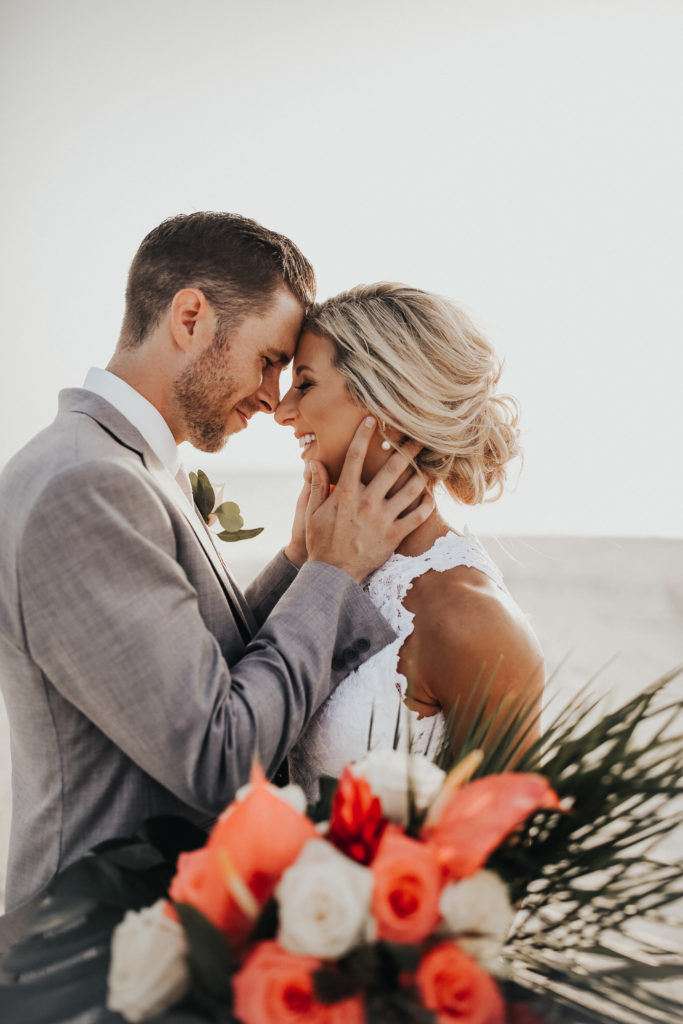 bride and groom on the beach on their wedding day