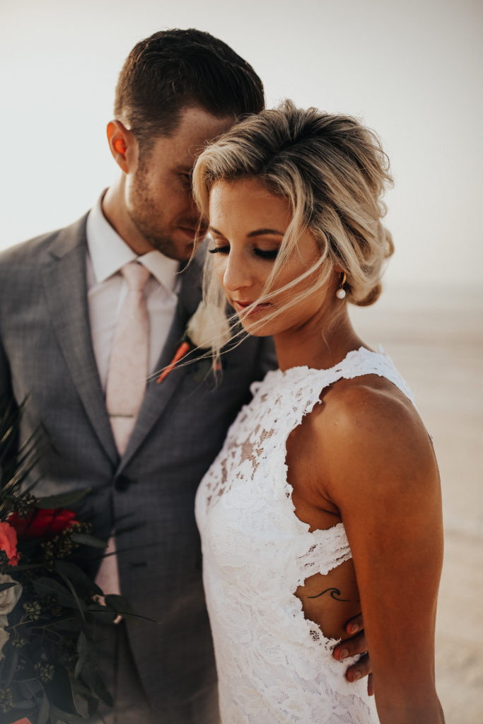 bride and groom on the beach on their wedding day