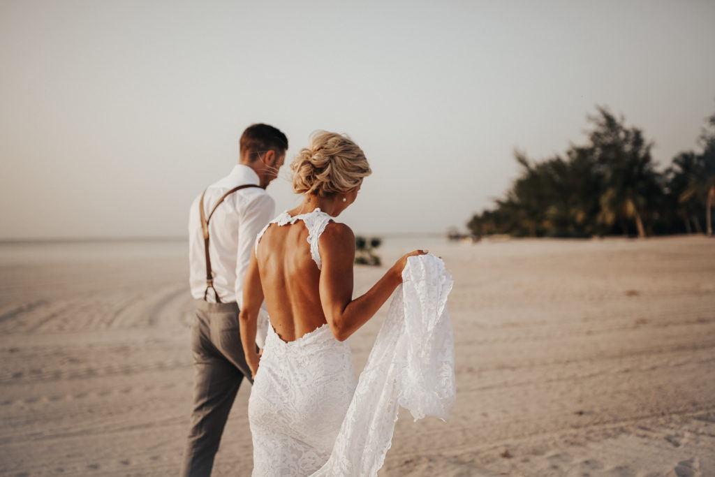 bride and groom on the beach on their wedding day