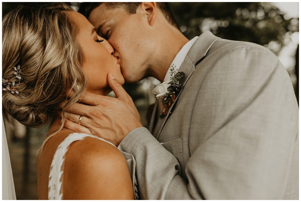 bride in boho lace wedding dress and blush bouquet with king protea and eucalyptus, groom in light grey suit