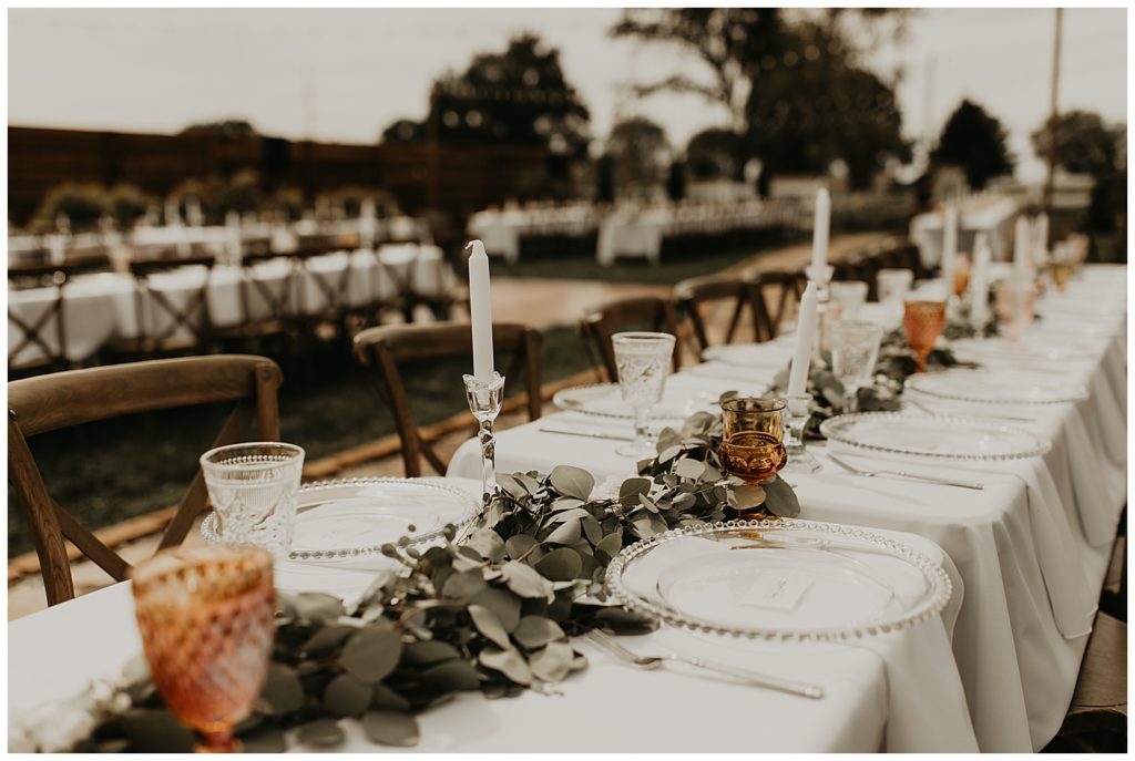 wedding reception at the marmalade lily in loveland ohio. tables with silver dollar eucalyptus greenery garland