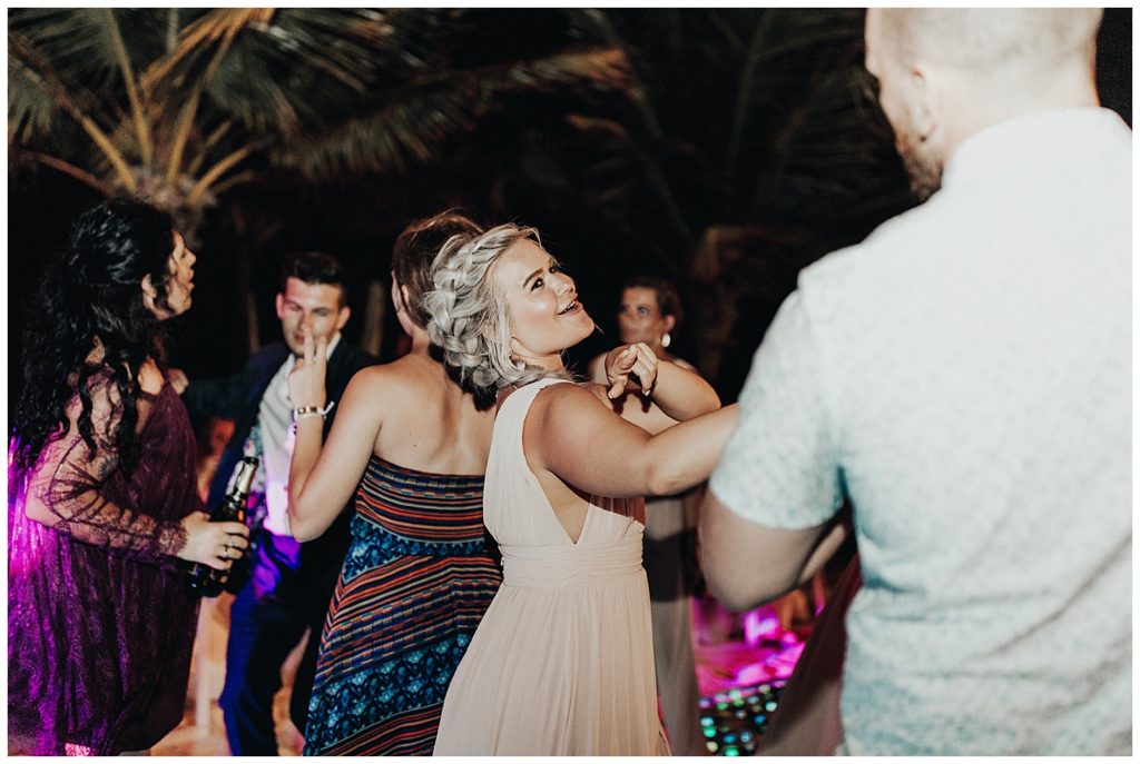 wedding guests dancing and partying on the beach during reception in cancun mexico