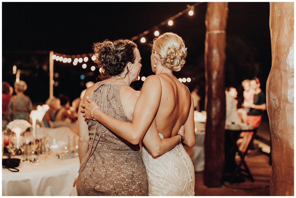 wedding guests dancing and partying on the beach during reception in cancun mexico