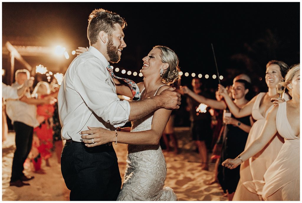 wedding guests dancing and partying on the beach during reception in cancun mexico