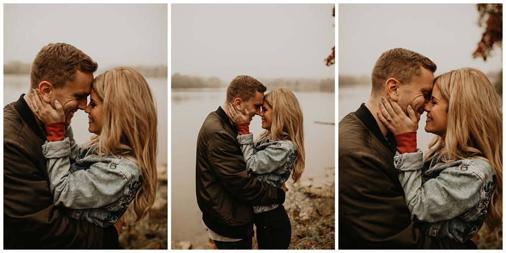 Engaged couple taking portraits by the river in Kentucky, surrounded by fall leaves