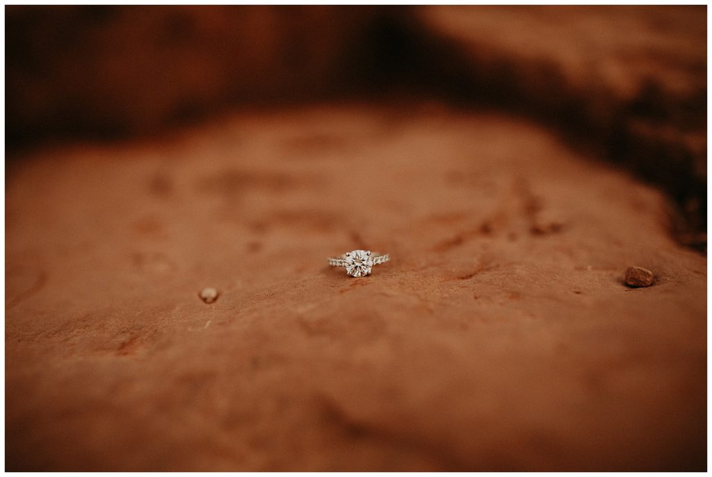 close up shot of engagement ring on the red rock of sedona arizona